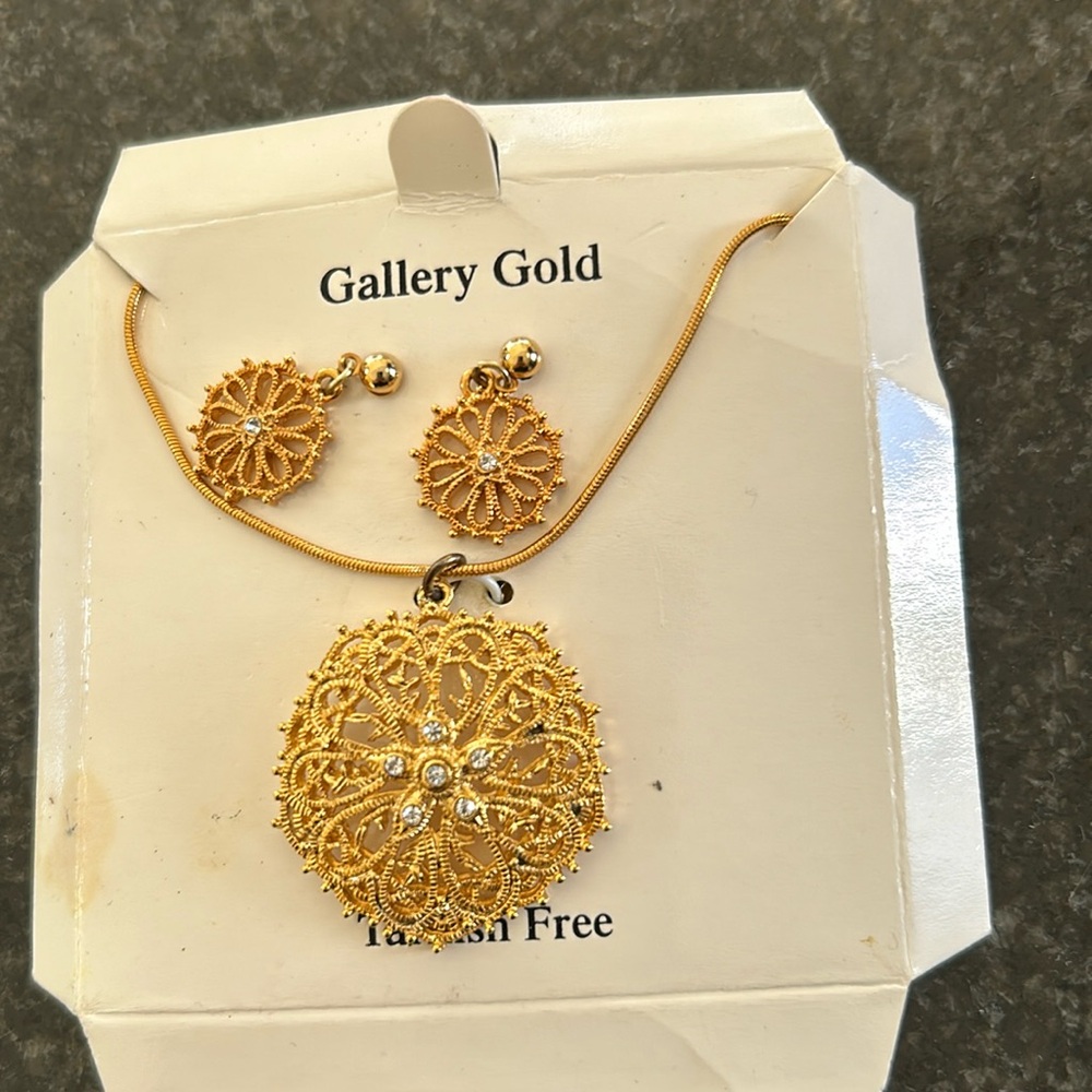 Gold colored earrings and matching necklace